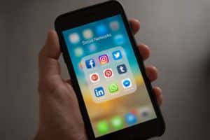 different social media apps on a cellphone screen.