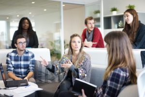 group of men and women in an office space.