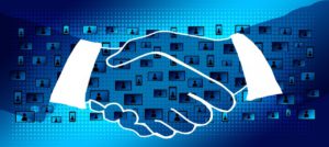 2 hands shaking with a network of people on screens behind as wallpaper.