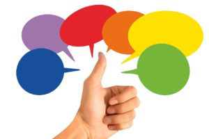 thumbs up with different colored speech bubbles around it
