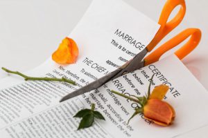 marriage certificate being cut by scissors
