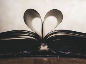 book open with the pages creating a heart