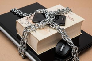 phone, book and laptop chained together