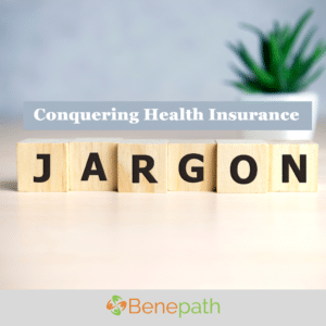 Conquering Health Insurance Jargon text overlaying image of wooden blocks spelling out jargon