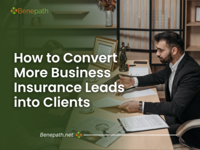 A professional insurance agent meeting with a client, representing strategies for converting business insurance leads into clients effectively.