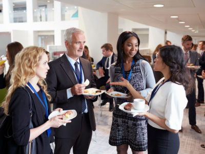 Professionals engaging in discussions during a networking session at an insurance industry conference.